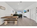 Bright and airy living room featuring neutral tones, tile flooring, and backyard access at 1934 Pond Pine Ct, Haines City, FL 33844