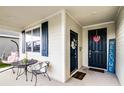 Cozy front porch area with seating, a welcome sign, and charming decor on the front door at 1982 Cricket Cradle Dr, Kissimmee, FL 34746