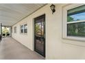 Exterior view of a screened door at the entrance of a condo unit at 200 El Camino Dr # 402, Winter Haven, FL 33884