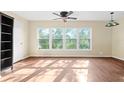 Living room featuring hardwood floors and a large window providing great natural light at 200 El Camino Dr # 402, Winter Haven, FL 33884