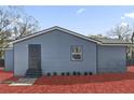 Home exterior showcasing gray siding, dark trim, walkway to door, and landscaping at 204 Brooks Rd, Frostproof, FL 33843