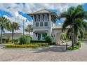 Elegant community entrance with beautiful landscaping, decorative flowers and striking architecture at 2132 Limestone Trl, Kissimmee, FL 34747