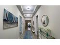 Inviting foyer with decorative mirrors, a blue rug, and recessed lighting leading into the home at 2132 Limestone Trl, Kissimmee, FL 34747