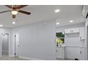 Bright living room with a ceiling fan, recessed lighting, and white trim at 25 N Van Buren Ave, Orlando, FL 32811