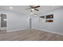 Inviting living space with wood-look flooring, a ceiling fan, and plenty of natural light at 25 N Van Buren Ave, Orlando, FL 32811