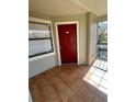 View of the private patio with neutral paint and a red door at 3008 Parkway Blvd # 302, Kissimmee, FL 34747