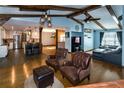 Inviting living room featuring exposed beams, hardwood floors, and an open concept design at 4124 Winderlakes Dr, Orlando, FL 32835