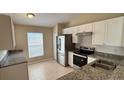 Well-lit kitchen features stainless steel appliances, granite countertops, and tile flooring at 458 Lancers Dr, Winter Springs, FL 32708