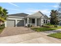 Beautiful single-Gathering home with a two-car garage, a cozy front porch, and a well-kept lawn at 4789 Terrace Bluff St, Winter Garden, FL 34787