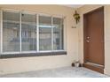 Close up of the front door, showing the house number, window and light fixture at 5415 Fairwood Way # 303, Orlando, FL 32808