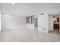 Bright living room featuring tile flooring, white walls, and an open floor plan at 5415 Fairwood Way # 303, Orlando, FL 32808