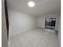 Spacious living area featuring tiled flooring and access to the outdoors at 5415 Fairwood Way # 303, Orlando, FL 32808