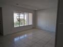 Living room with tile floors, blinds, and ample natural light at 5415 Fairwood Way # 303, Orlando, FL 32808