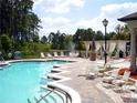 Community pool area offering ample seating, gazebo, and views of the surrounding greenery and water feature at 713 Crest Pines Dr # 227, Orlando, FL 32828