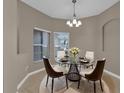 Cozy dining area with a glass table, stylish chairs, and soft lighting, creating a welcoming atmosphere at 864 Stonechase Ln, Lake Mary, FL 32746