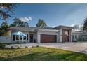 Charming home features a spacious driveway, lovely front yard with lush landscaping and an inviting exterior design at 105 Pine Street, Windermere, FL 34786