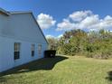 Side yard showcases lush greenery and a spacious lawn at 13900 Corrine Key Pl, Orlando, FL 32824