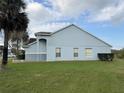 View of a house's exterior showing lawn and stucco wall at 13900 Corrine Key Pl, Orlando, FL 32824