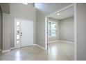 Bright foyer featuring tile floors, a front door with sidelight, and an entryway to another room at 15165 Heron Hideaway Cir, Winter Garden, FL 34787