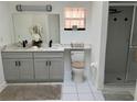 Bright bathroom featuring double vanity with modern fixtures and a walk-in shower at 2013 Bates Ave, Eustis, FL 32726