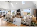 Bright and airy living room featuring a fireplace, vaulted ceilings, and large windows at 2045 Green Cedar Ln, Geneva, FL 32732