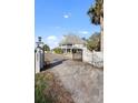 Charming gated entrance to a beach house property with a well-maintained driveway at 2045 Green Cedar Ln, Geneva, FL 32732