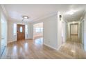 Bright foyer featuring wood flooring, a decorative front door, and a view into living spaces at 2123 Alameda St, Orlando, FL 32804