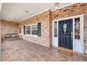 Inviting front porch features decorative glass door, black shutters, and a cozy porch swing at 2123 Alameda St, Orlando, FL 32804