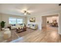 Bright living room with wood flooring, a ceiling fan and view into the dining room at 2123 Alameda St, Orlando, FL 32804