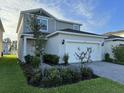 Charming two-story home with a well-maintained lawn and a brick paver driveway at 2369 Palm Park Loop, Clermont, FL 34714