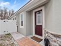 Close-up of a home's front door with a brick walkway and a white picket fence at 2479 Empress Dr, Kissimmee, FL 34741