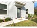 Home entrance featuring a dark door, and a well-maintained lawn at 2623 Buena View Rd, Kissimmee, FL 34746