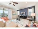 Open-plan living room with large windows to the lanai that provide natural light at 300 Burma St, Kissimmee, FL 34747