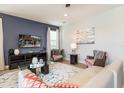 Comfortable living room featuring stylish furnishings, a modern rug, and a TV wall mount at 300 Burma St, Kissimmee, FL 34747