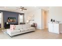 Bright and airy living room with a large couch, a ceiling fan, and neutral-colored walls at 300 Burma St, Kissimmee, FL 34747