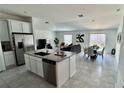 Modern kitchen featuring stainless steel appliances, a kitchen island, and an open floor plan at 313 Estates Ct, Haines City, FL 33844