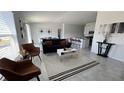 Inviting living room with tile floors, neutral decor, modern furnishings, and plenty of natural light at 313 Estates Ct, Haines City, FL 33844