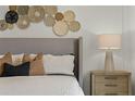 Cozy bedroom showcases decorative wall hangings above the headboard and stylish nightstand at 3350 Private Oak Dr, Apopka, FL 32703