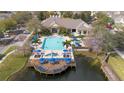 Aerial view of the community pool, hot tub, clubhouse, and deck overlooking the water at 4008 San Gallo Dr # 102, Kissimmee, FL 34741