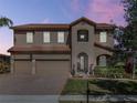 Charming two-story home with three-car garage, tile roof and manicured lawn at 4903 Eastlake Vista Dr, St Cloud, FL 34771