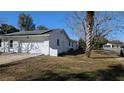 Side view of home showcasing white exterior paint and well-kept landscaping at 50 Avalon Ct, Casselberry, FL 32707