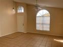 Inviting living room with tile flooring, ceiling fan, and natural light from arched windows at 513 Seasons Ct, Winter Springs, FL 32708