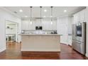 Bright kitchen with white cabinets, stainless steel appliances, and granite countertops at 583 Treehouse St, Winter Springs, FL 32708