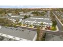 Wide aerial shot of a townhome community displaying well-kept landscaping, roofs, and ample parking at 7659 Sir Kaufmann Ct, Kissimmee, FL 34747