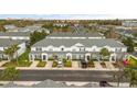 Aerial view of townhomes showcasing a well-maintained community with landscaping and ample parking at 7659 Sir Kaufmann Ct, Kissimmee, FL 34747