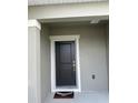 Close up on the front door with a Welcome mat at 9436 Westside Hills Dr, Davenport, FL 33896