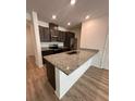 Modern kitchen featuring stainless steel appliances and an island with granite countertops at 9436 Westside Hills Dr, Davenport, FL 33896