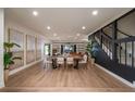 Spacious dining area flowing into the living room with wood floors and modern decor at 9575 Ne 306Th Ct, Fort Mc Coy, FL 32134