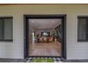 Inviting entryway view of dining and living areas featuring wood floors and lots of natural light at 9575 Ne 306Th Ct, Fort Mc Coy, FL 32134