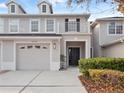 Close up shot of a well-maintained townhome with a two-car garage at 1218 Falling Star Ln, Orlando, FL 32828